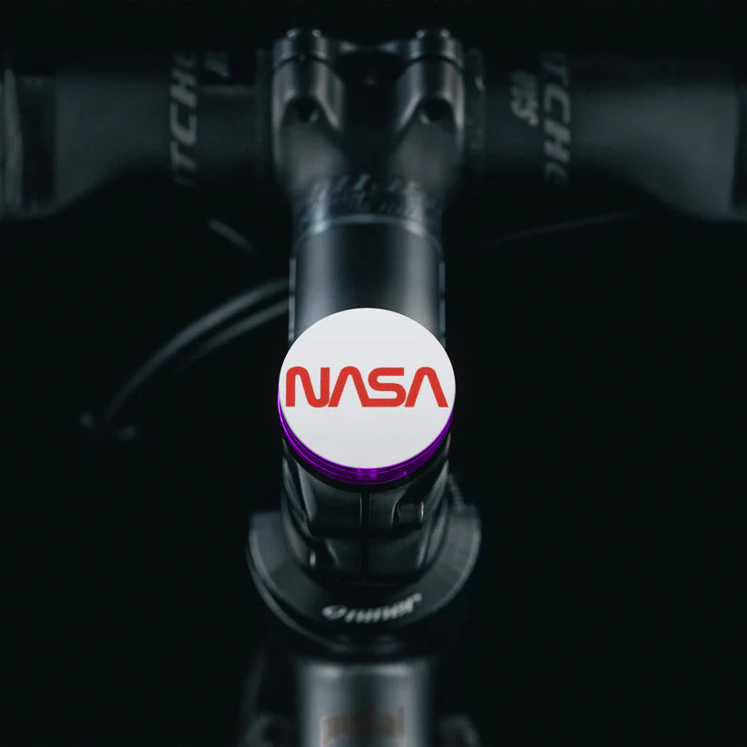 Purple Shapeshifter top cap for bicycles with NASA worm logo.