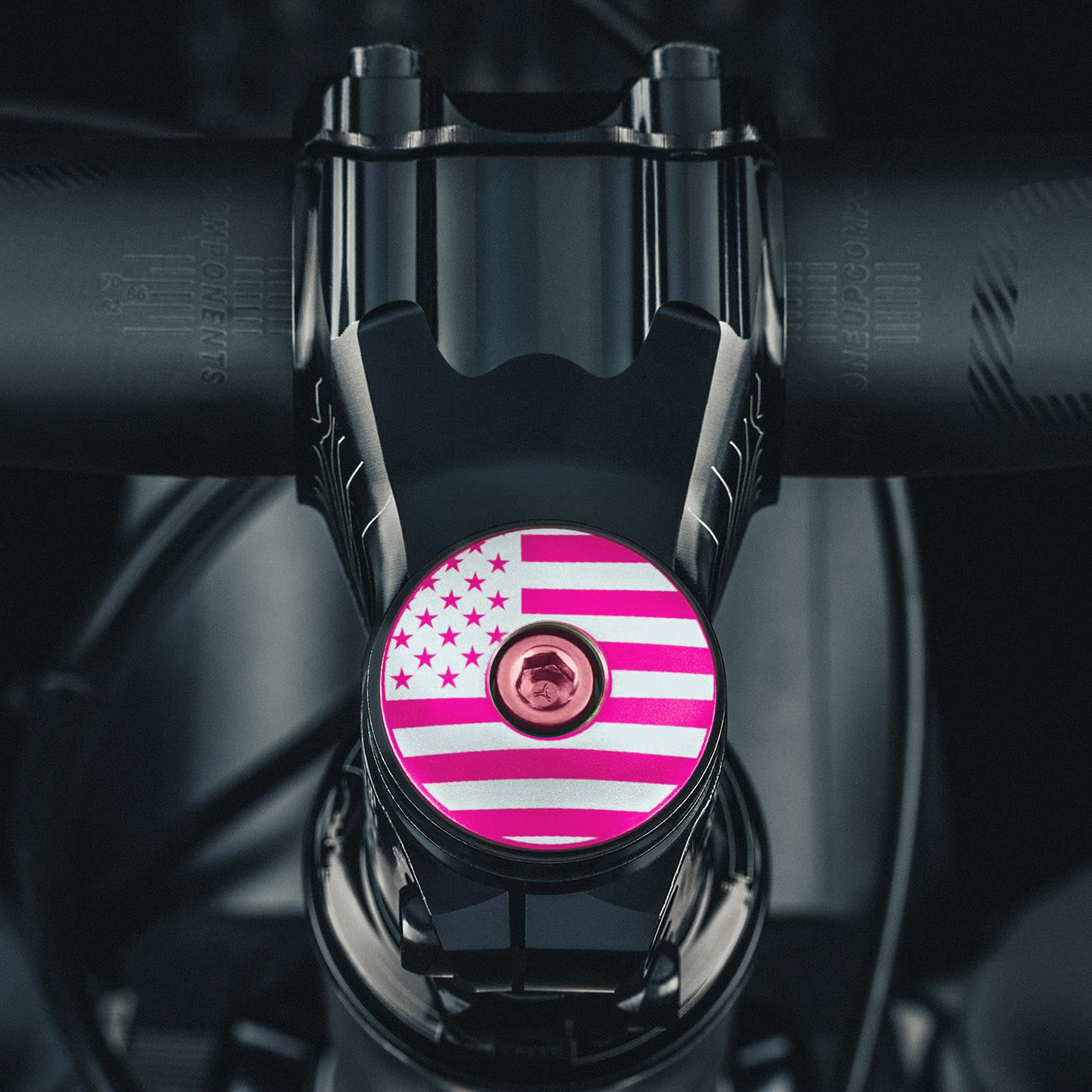 Hot pink stem cap with a sleek design for personalized bike accessories