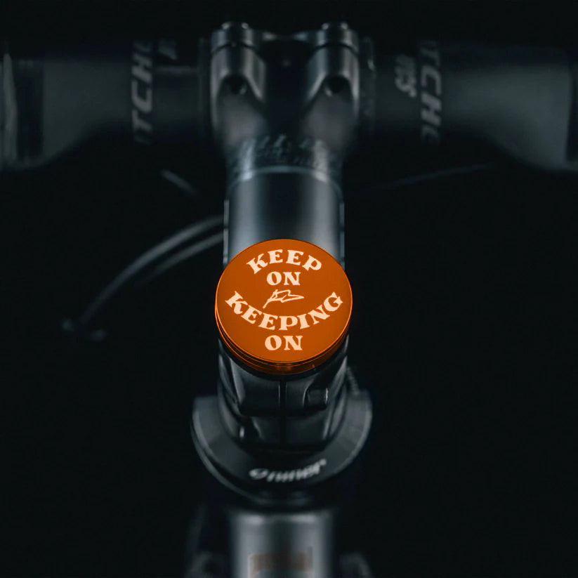 Brown headset cap with custom hand-drawn design and flat top.