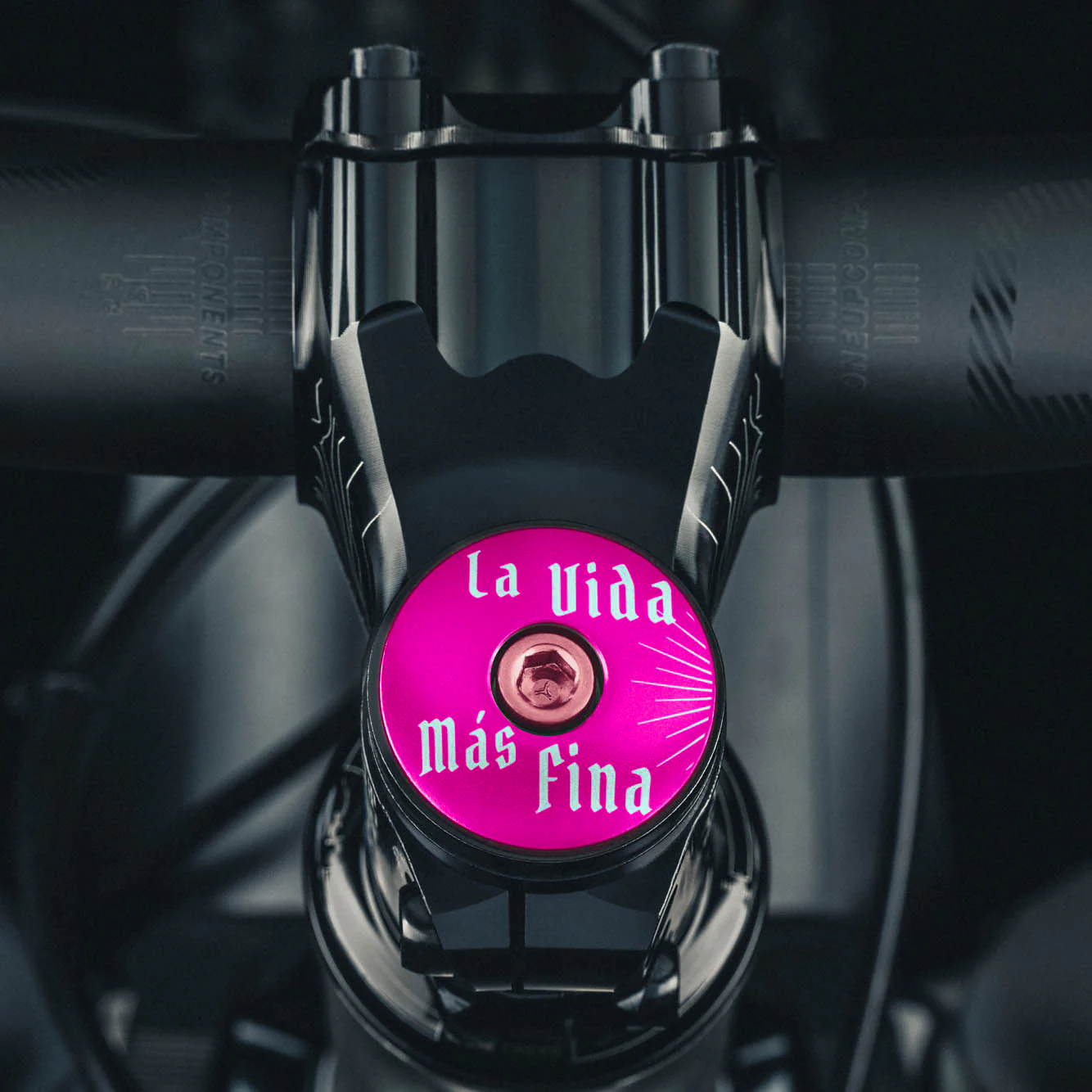 Hot pink bike stem cap for eye-catching personalization.
