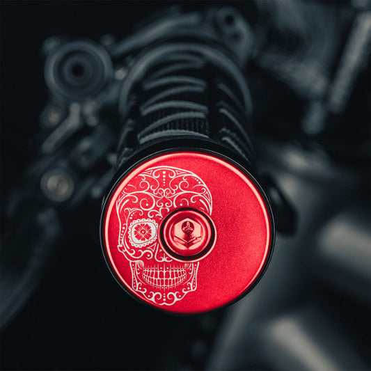 Red bicycle bar end plugs for custom road or mountain bike setups.