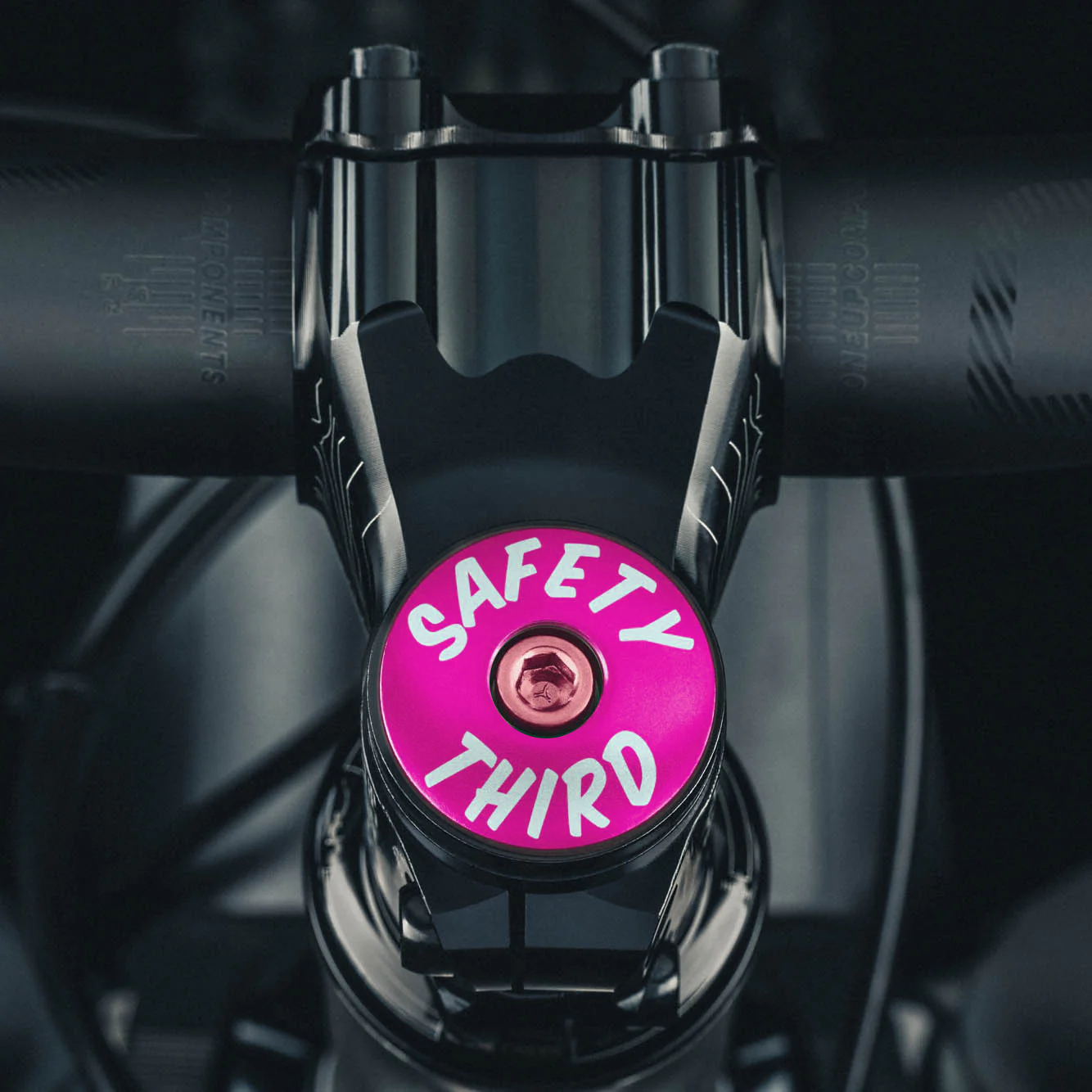 Hot pink stem cap designed for 1 1/8" steerer tubes, perfect for a colorful touch to your bike.