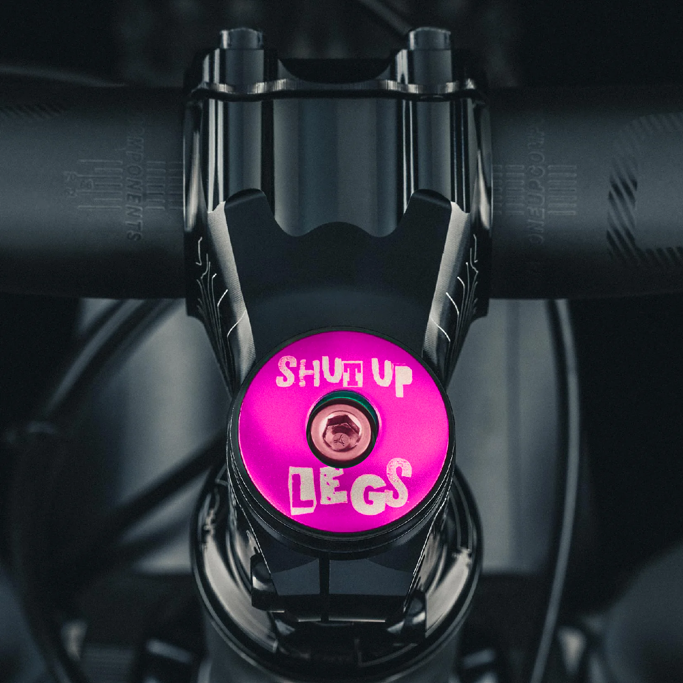 Hot pink bicycle headset cap with Shut Up Legs design fits 1 1/8-inch steerer tubes ideal for bike upgrades.