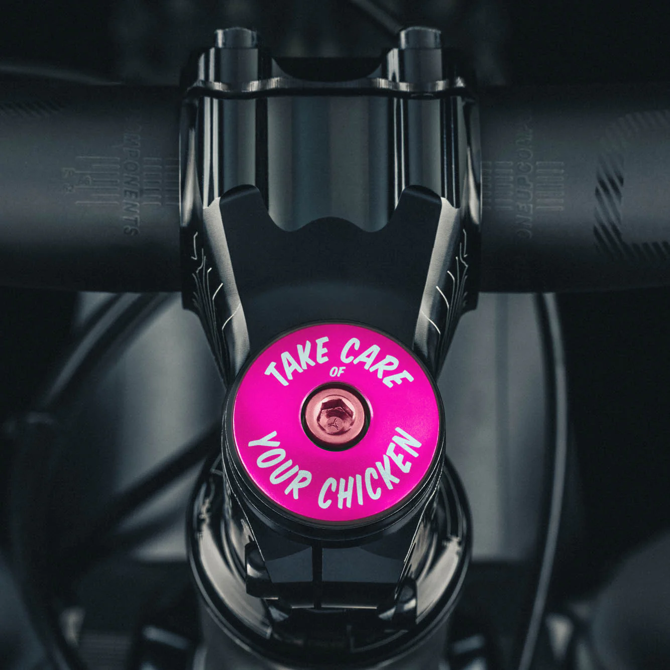 Hot pink bicycle headset cap for 1 1/8 inch steerer tubes made from durable aluminum for bike customization.