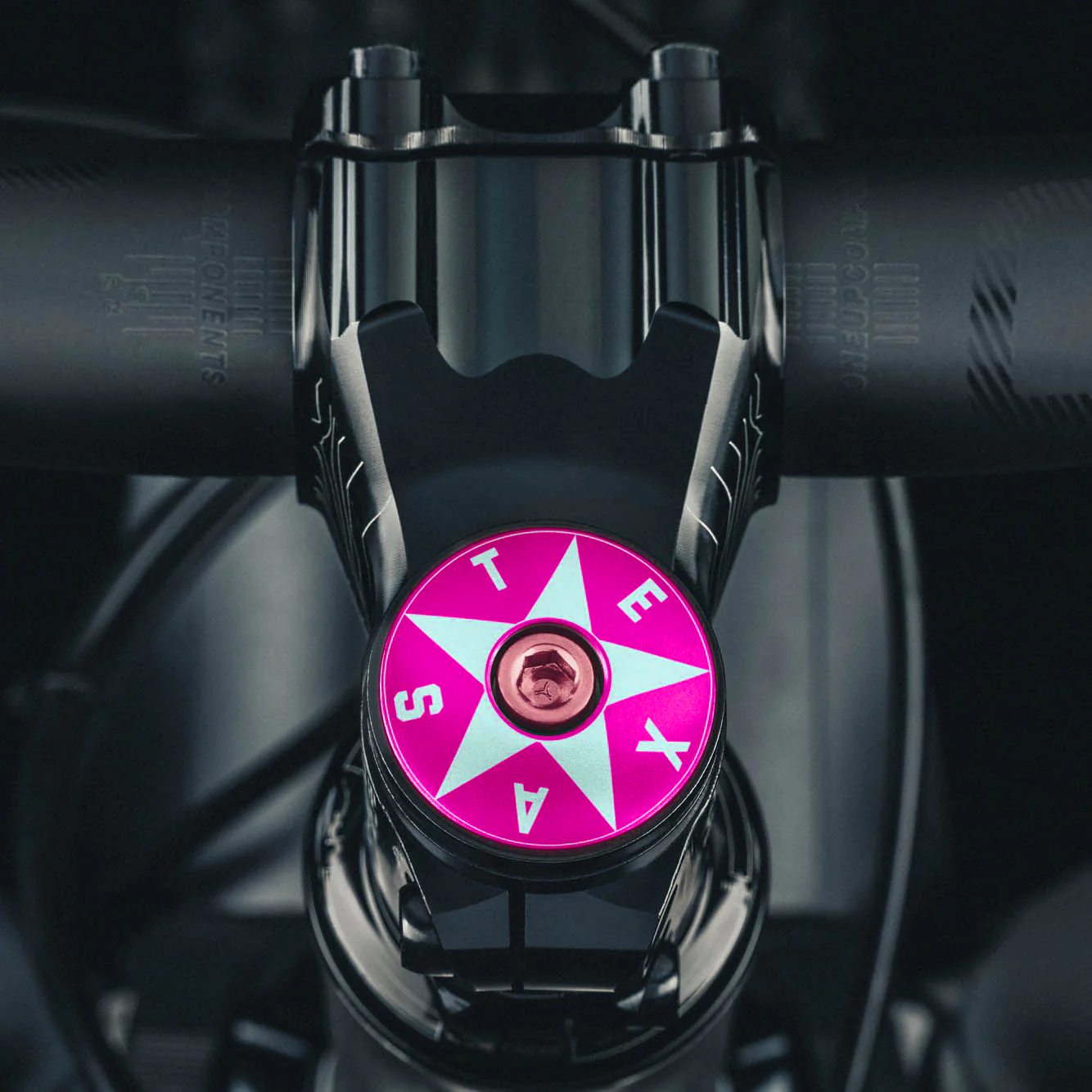 Hot pink bike headset top cover featuring a Texas-themed star design.