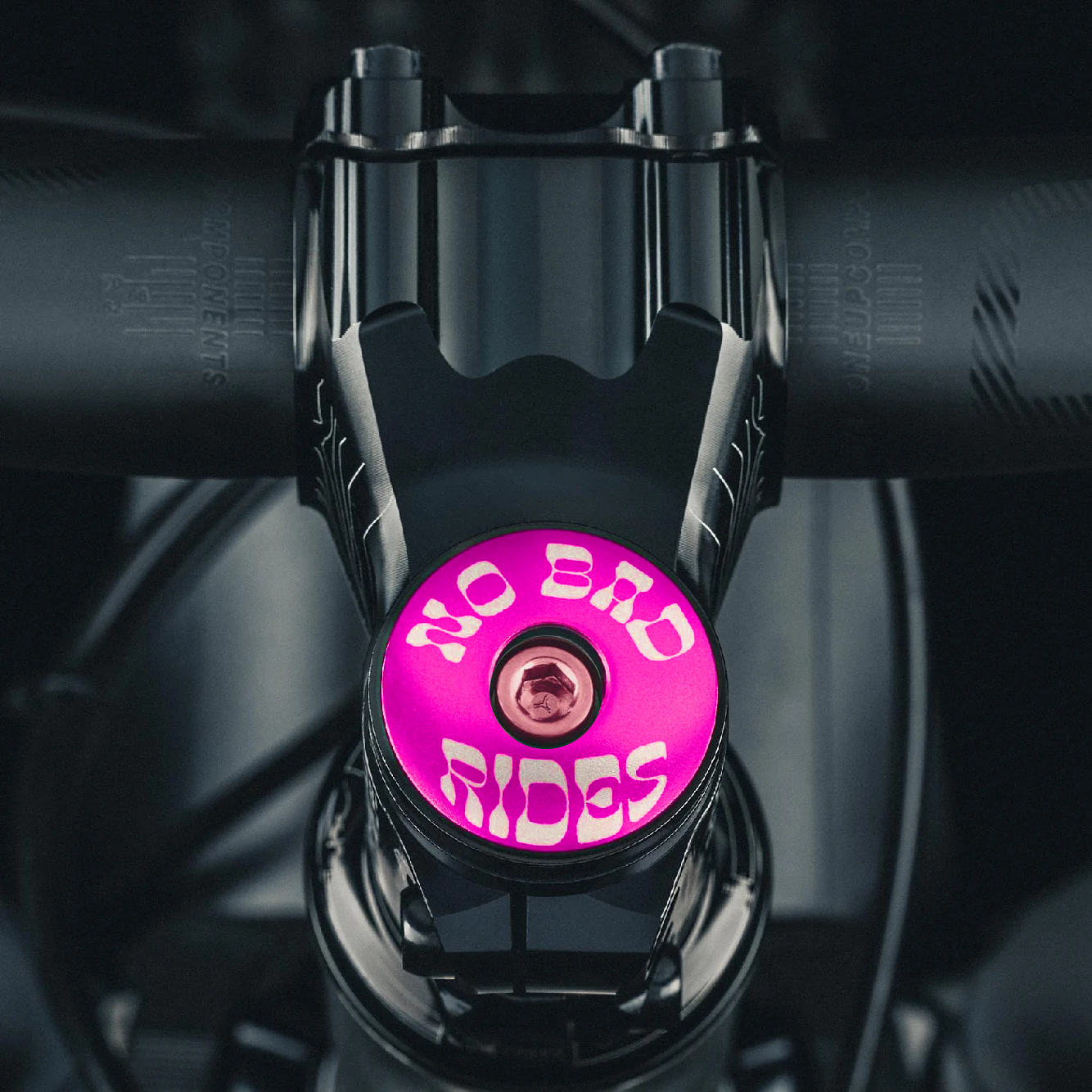 Hot pink custom bike headset cap showing 'No Bad Rides' message for cyclists