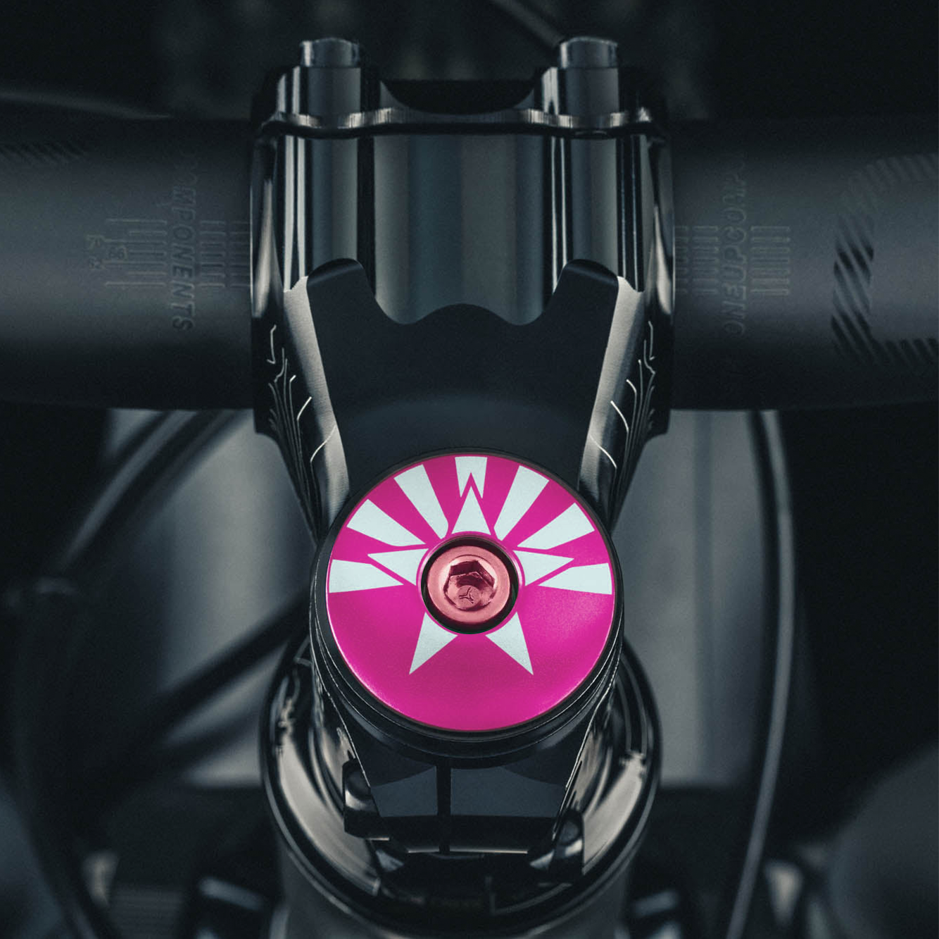 Vibrant hot pink bike stem cap with an Arizona flag design for personalized cycling gear.