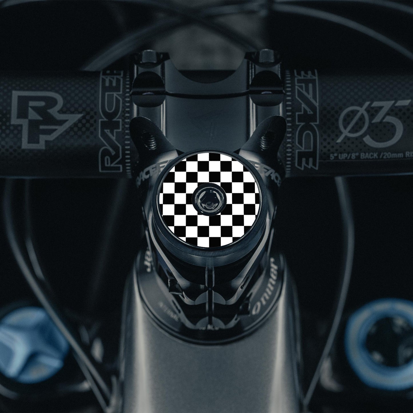 Flat black bicycle headset cap with a UV-printed checkerboard pattern for cycling top cap upgrades