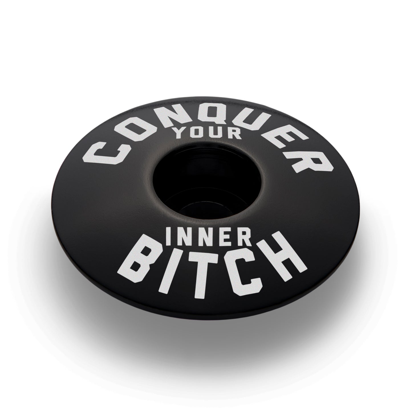 Black bicycle headset cap for road bikes or mountain bikes adding a sleek custom touch to cycling equipment.