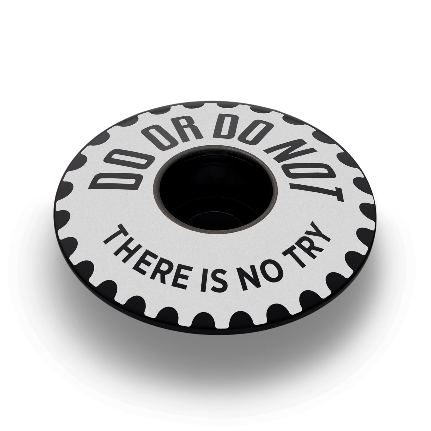 Black bicycle headset cap for mountain bikers with a sleek design.