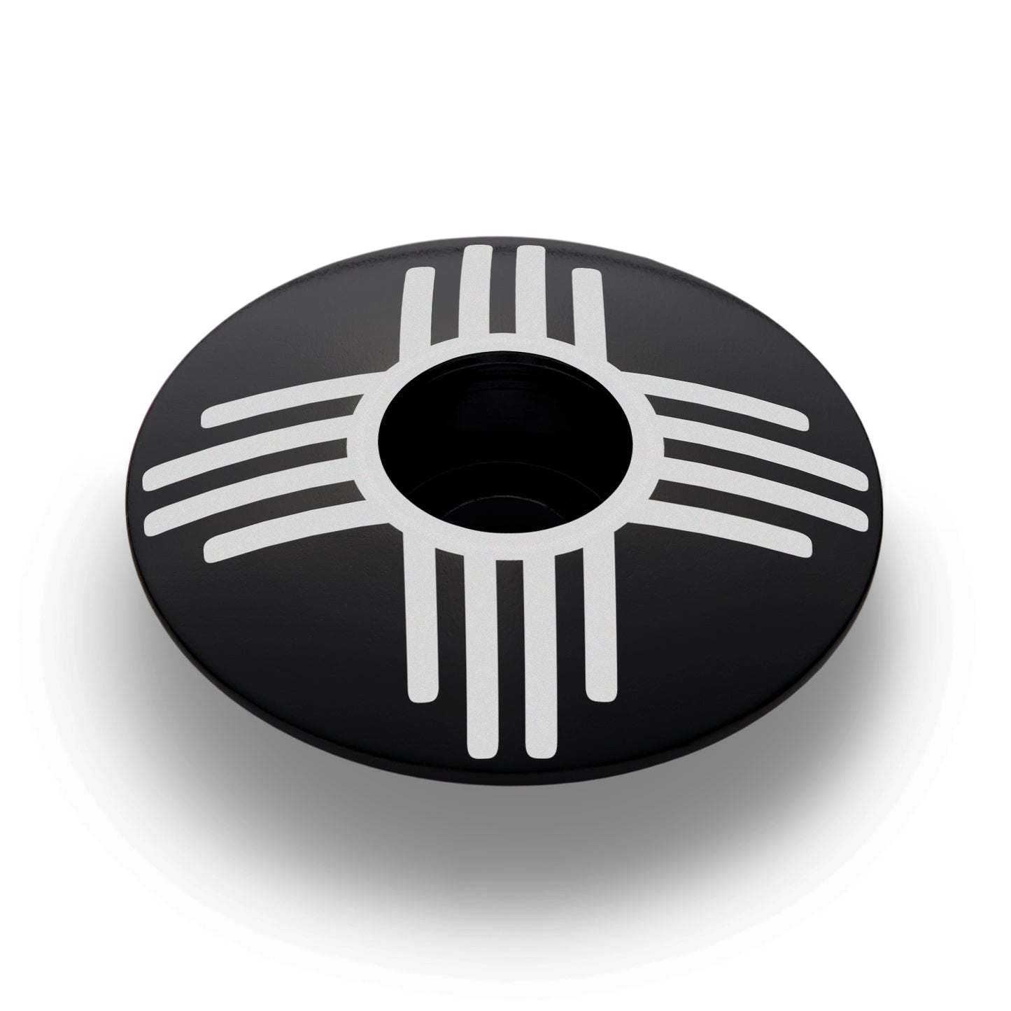 Bicycle headset cap with Zia symbol in black, custom stem cap for personalized bike components.