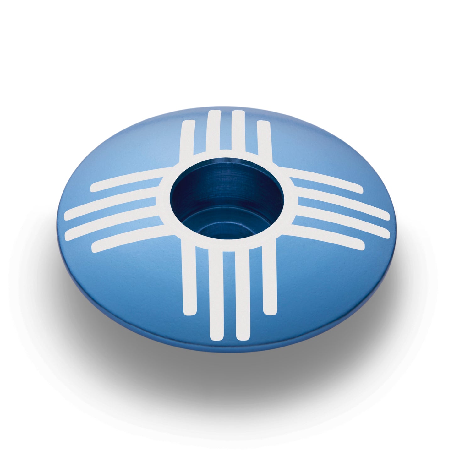 Light blue bike headset top cap with Zia symbol, a great addition to bike components.