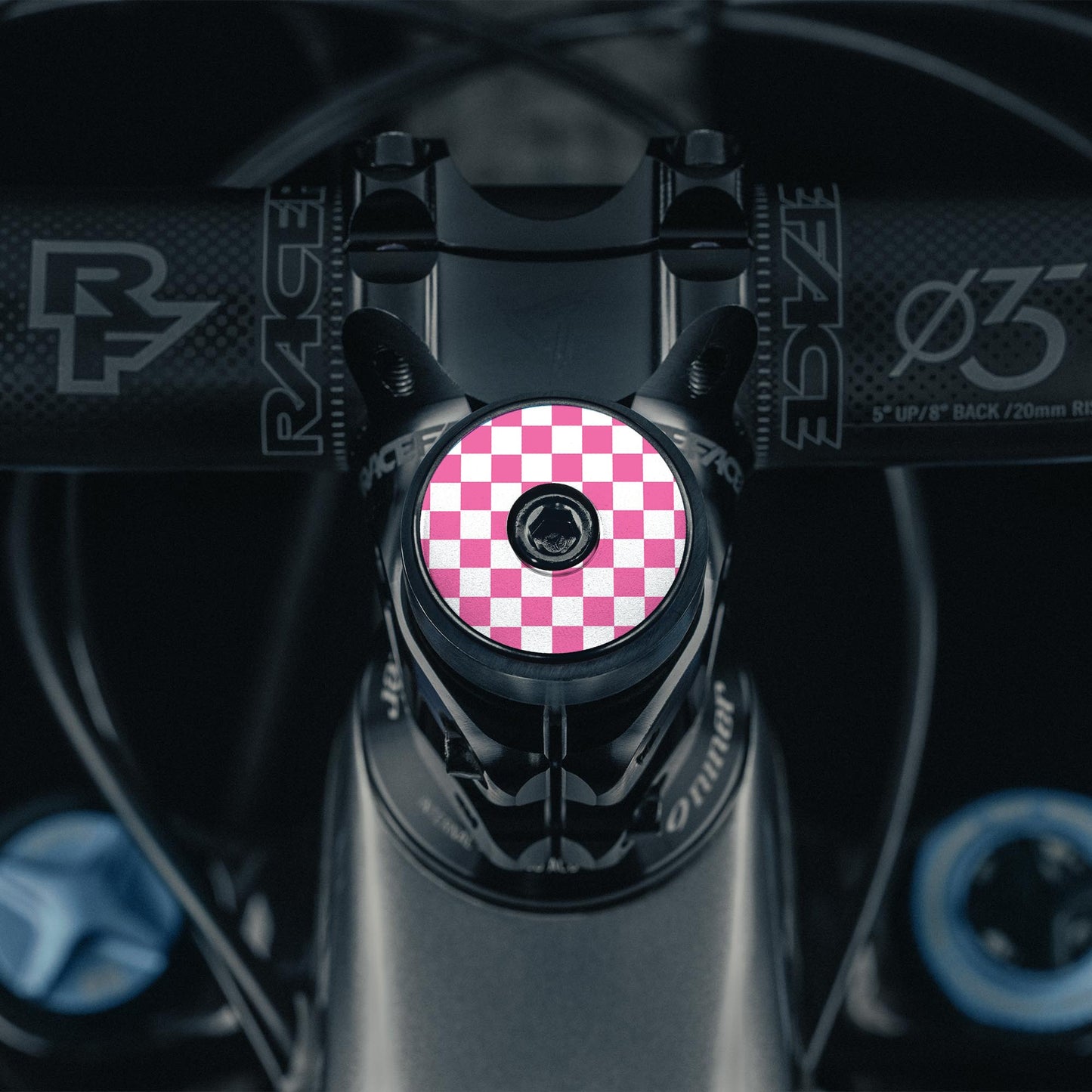 Pink bicycle headset cap with a vibrant UV-printed checkerboard design for stylish bike headset upgrades