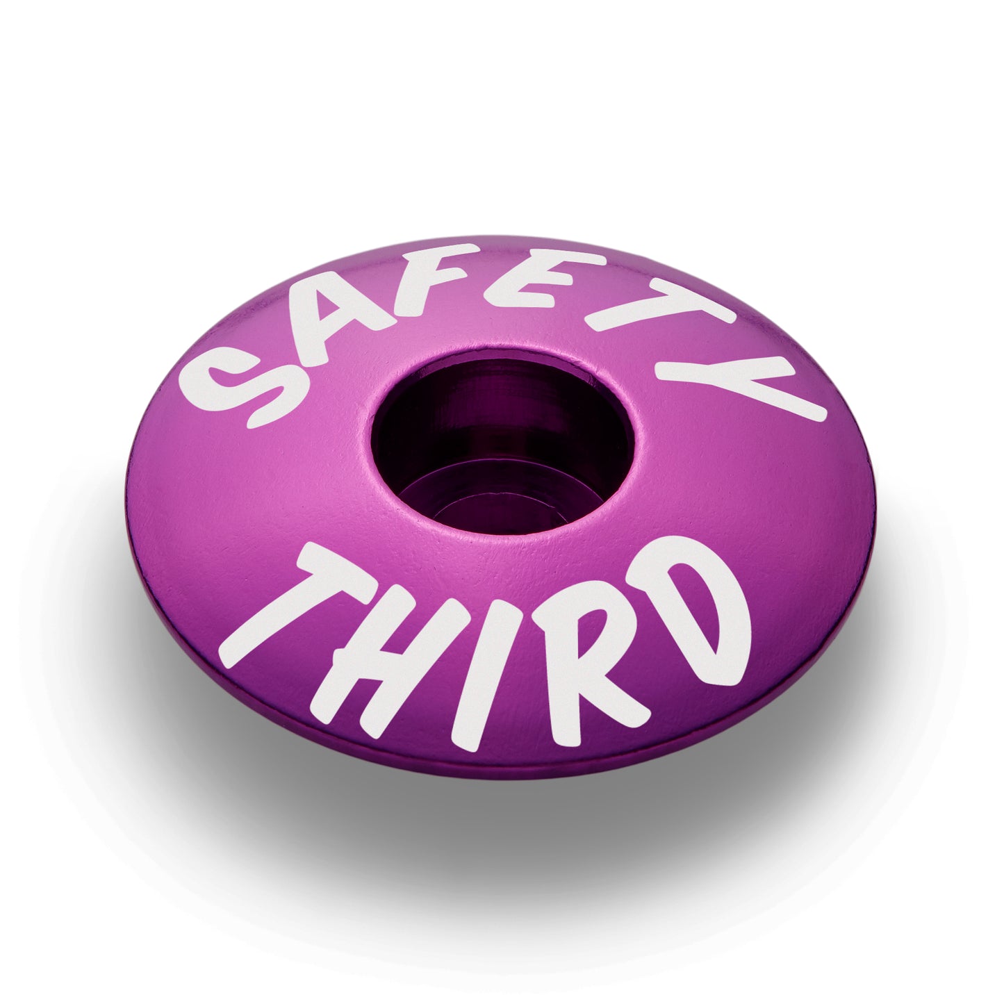Purple bicycle headset cap for a custom bike setup with a durable aluminum design.