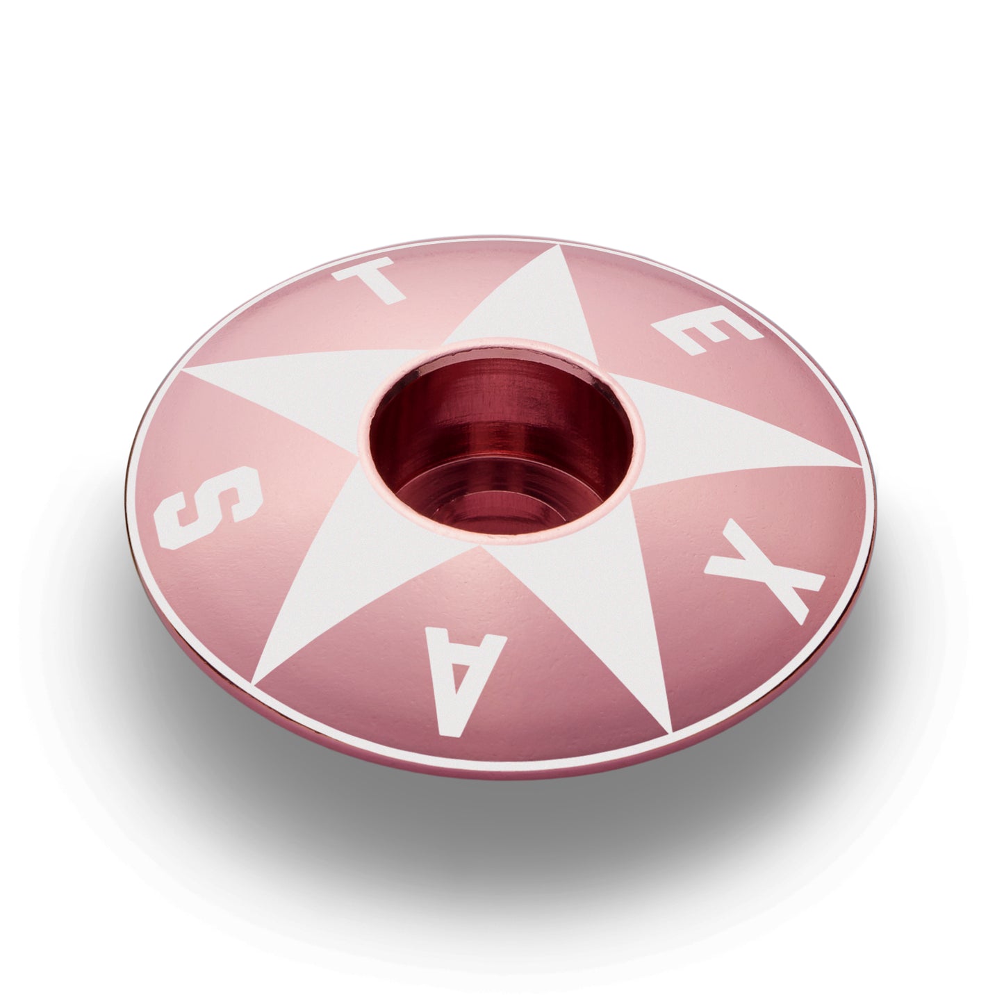 Pink mountain bike stem cap with a bold Texas star design.