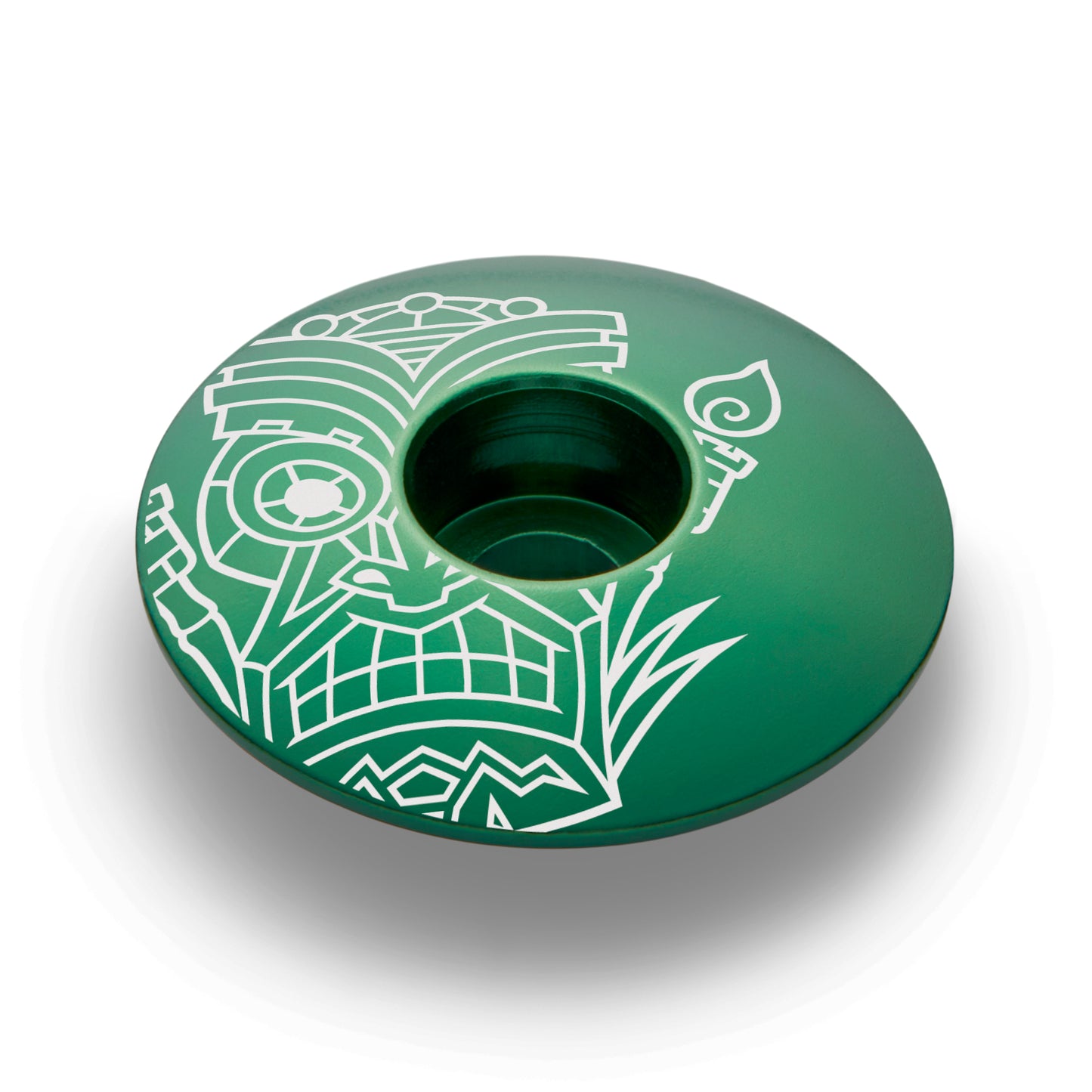 Dark green bike top cap with a tiki design made of lightweight and strong aluminum.