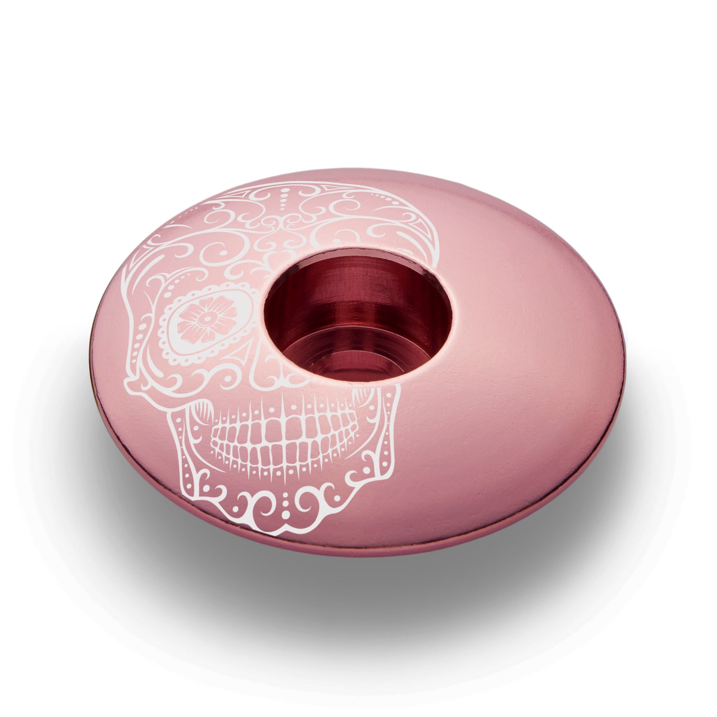 Vía de Muertos pink bike stem cap, the custom top cap for a headset, and cycling accessories.