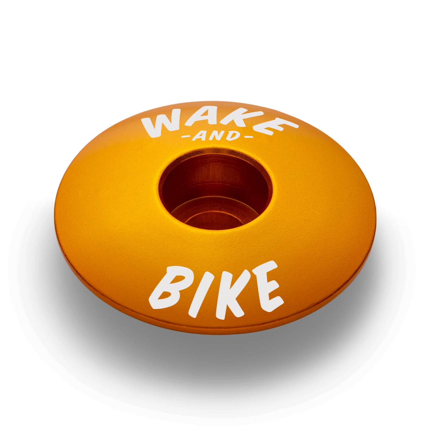 Gold bike headset top cap for added style and practicality on road and mountain bikes.