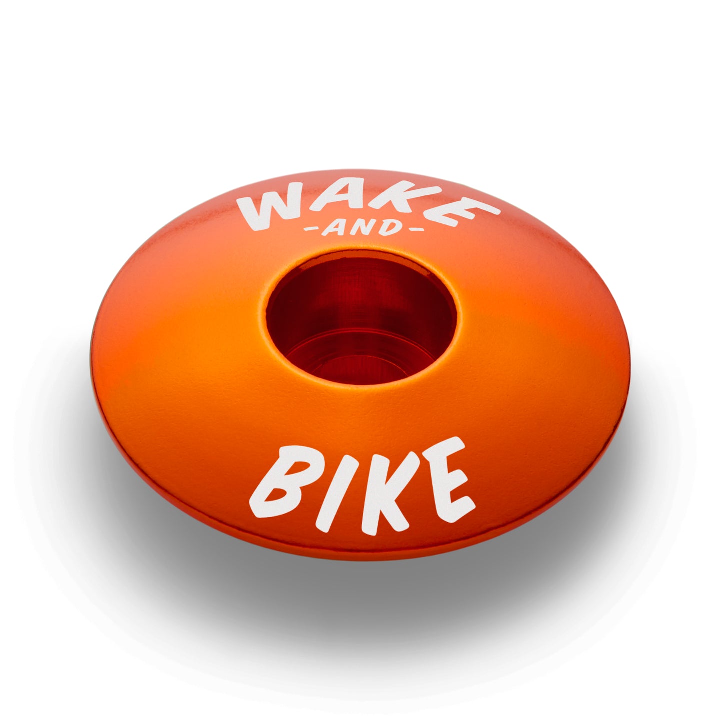 Orange bicycle headset cap designed to fit 1 1/8" steerer tubes for an easy installation.