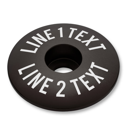 Black bike bar end plugs with matching headset cap and bolt designed for road or mountain bikes