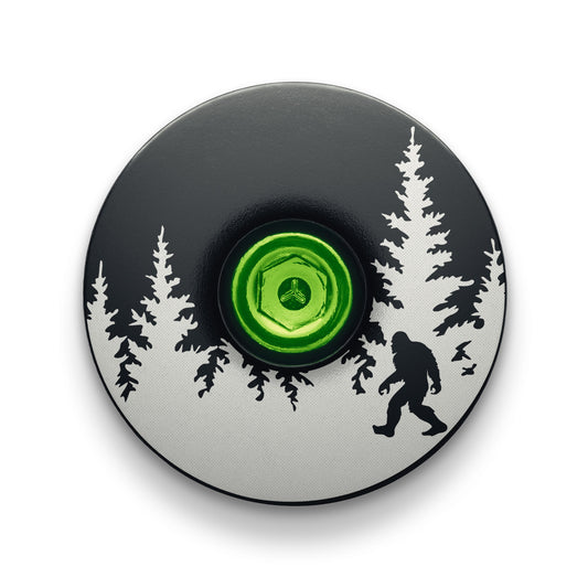 Black bike headset cap with Bigfoot design made of lightweight aluminum for personalized cycling accessories.