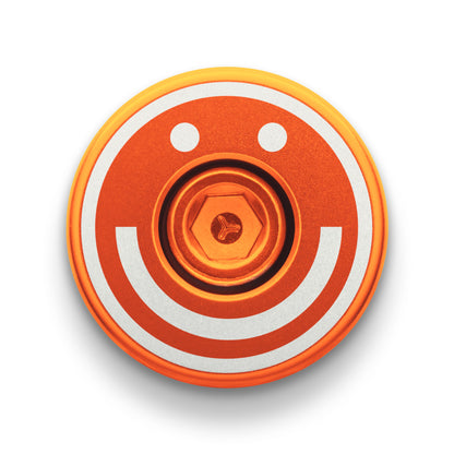 Orange bicycle bar end plugs for secure handlebar fit.