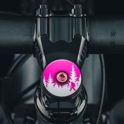 Hot pink stem cap with Bigfoot engraving a bold choice for custom bike headset caps.