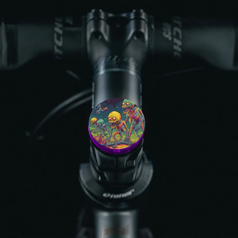 Rich purple stem cap with colorful alien design for custom bicycle accessories.