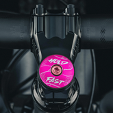 Hot pink bike stem cap for modern bikes with a colorful finish.