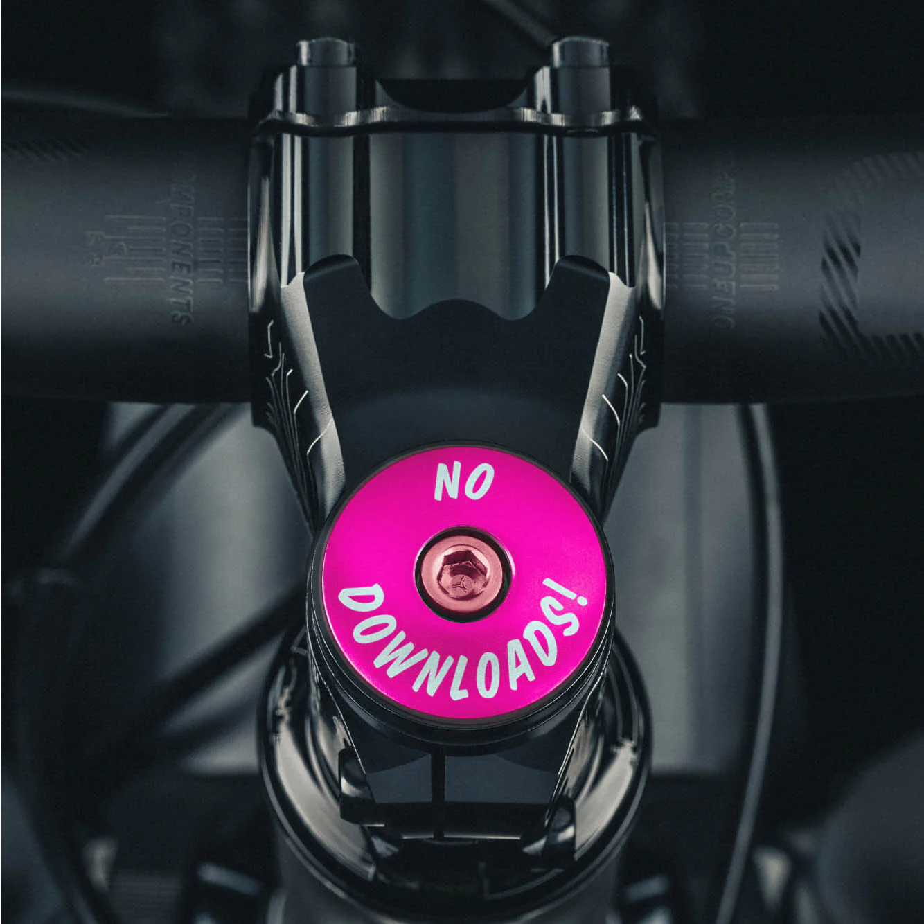 Hot pink custom stem cap with 'Grip and Rip' message for a unique bike upgrade.