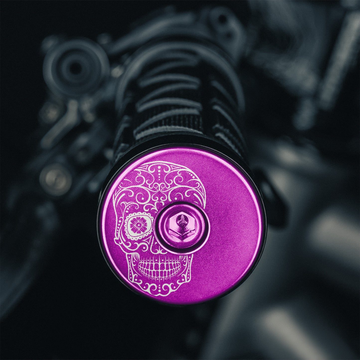 Purple bicycle bar end plugs for MTB or road bike handlebars.