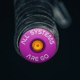Purple road bicycle bar end plugs with lightweight aluminum for enhanced handlebar protection.