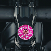 Hot pink bike headset cap designed to fit 1 1/8" steerer tubes for a personalized cycling accessory.