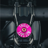 Hot pink custom stem cap for a bold bike accessory upgrade.