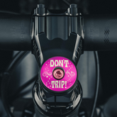 Hot pink stem cap for an eye-catching custom bike component.