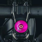 Hot pink custom headset top cap for bikes with engraved lettering.