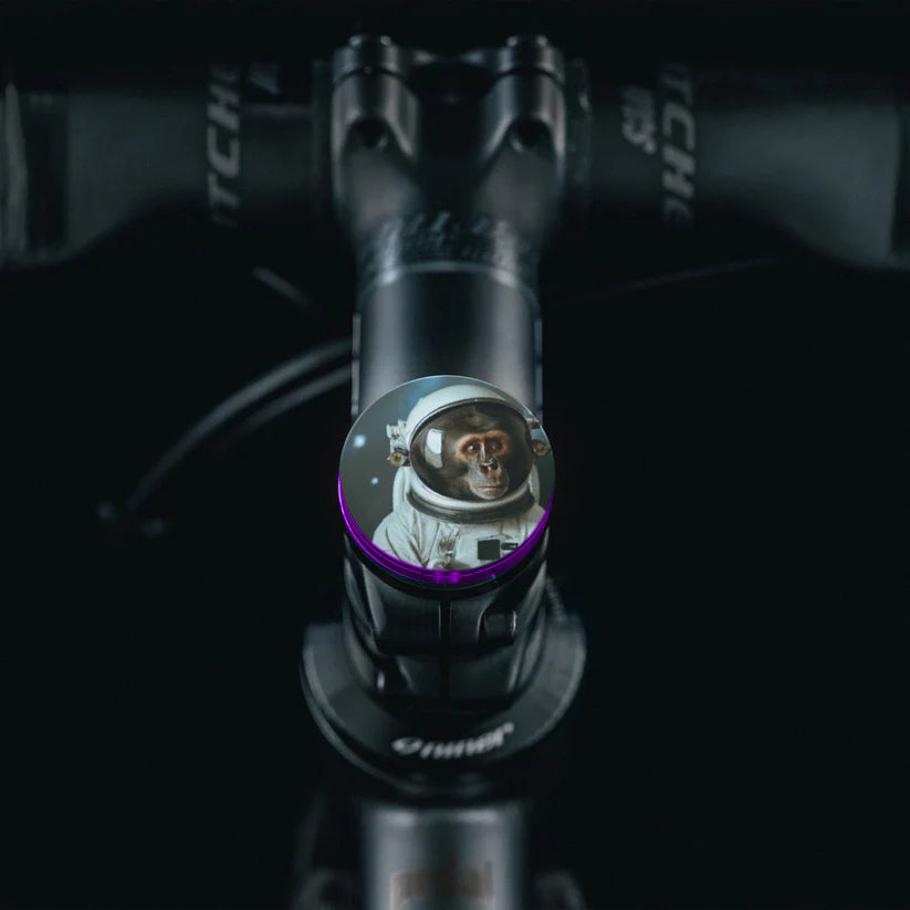 Unique purple bicycle stem cap with concealed bolt design.