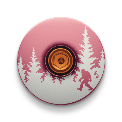 Pink stem topcap with Bigfoot design a fun and personalized bike accessory.