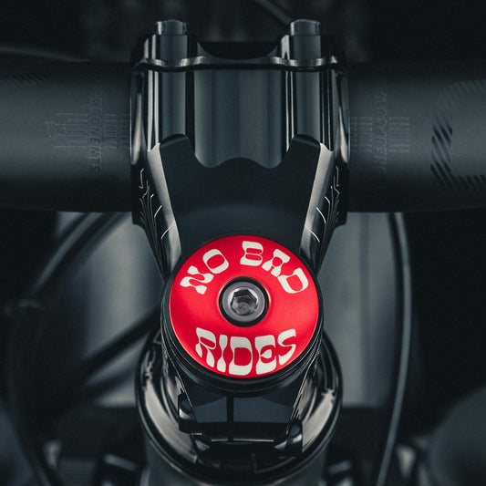 Red bike headset top cap engraved with 'No Bad Rides' message for cyclists