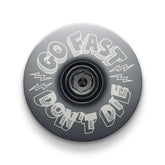 Gray bike headset top cap crafted for strength and style with a Go Fast Don’t Die touch.