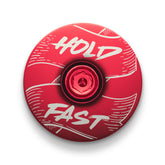 Red bicycle headset cap for road and mountain bikes fits standard steerer tubes.