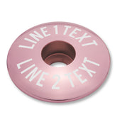 Pink bicycle bar end plugs and headset cap set for mountain or road bike personalization.