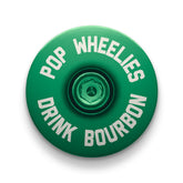 Dark green bicycle stem cap made from durable aluminum for personalized cycling gear.