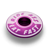 Purple Ride Ass Eat Fast bike headset cap for 1 1/8 steerer tubes adds personality to your bicycle top cap.