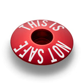 Red bike stem cap for adding a personal touch to your bicycle setup.