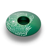 Dark green bike top cap with a tiki design made of lightweight and strong aluminum.