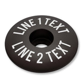 Black bike bar end plugs with matching headset cap and bolt designed for road or mountain bikes